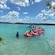 A group of people in the water with inflatable rafts